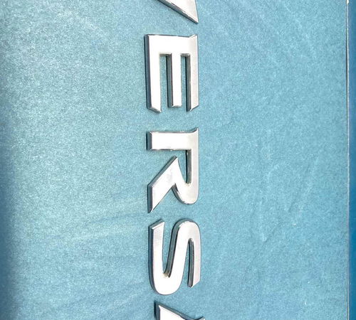 Emblema Escrita Capo Ts. Nissan Versa  2016
